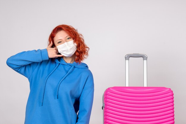 Front view female tourist with pink bag in mask