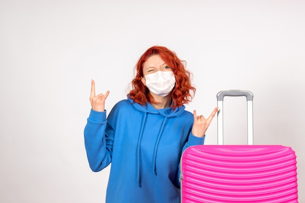 Front view female tourist with pink bag in mask