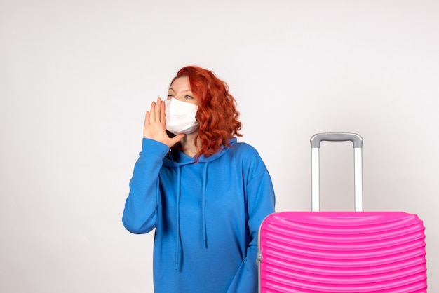 Front view female tourist with pink bag in mask