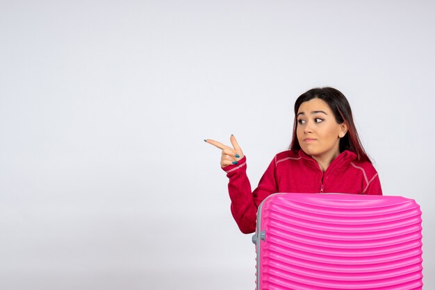 Front view female tourist with pink bag on white wall