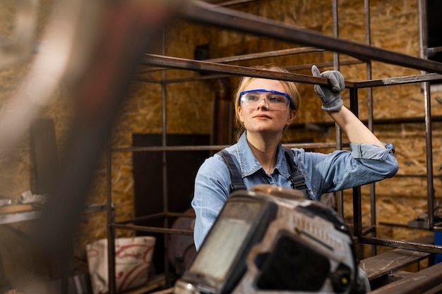 Free photo front view of female welder at work