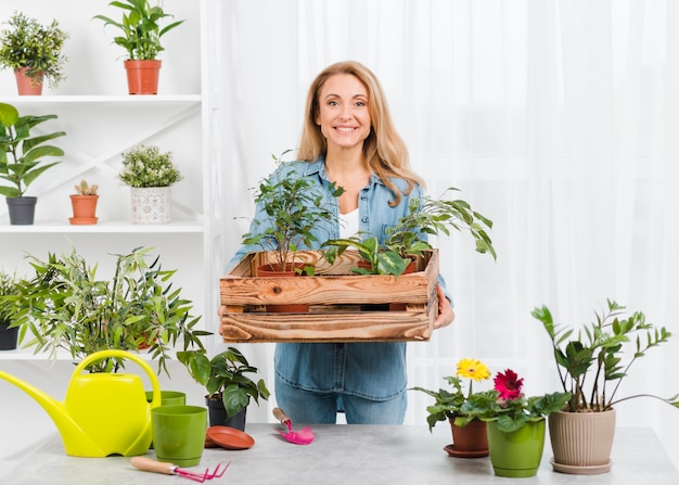 Free photo front view female with flowers pot