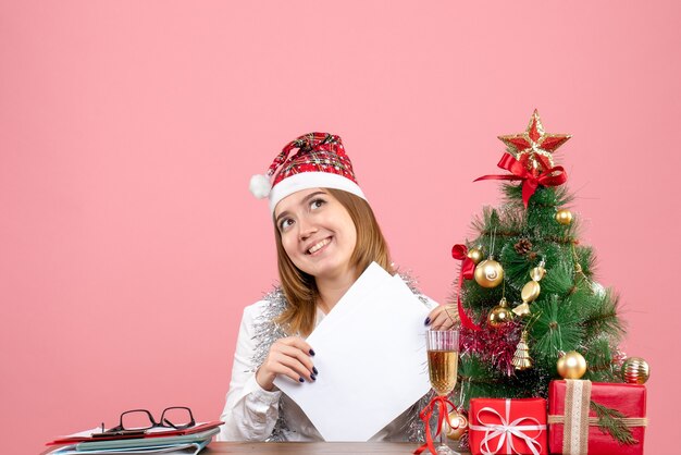 Free photo front view of female worker holding documents on pink