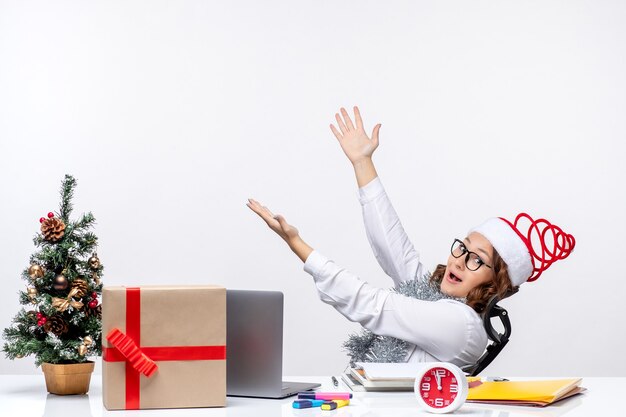 Free photo front view female worker sitting before her working place job office business xmas