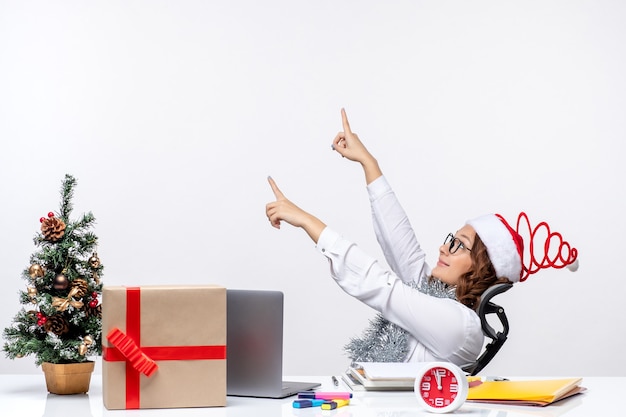 Front view female worker sitting before her working place office work business christmas job