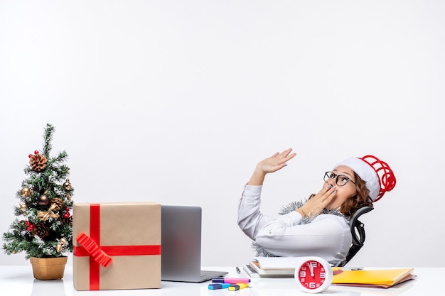 Front view female worker sitting before her working place shocked job office work business xmas