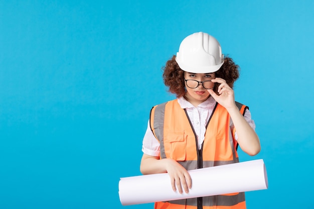 Free photo front view of female worker in uniform on the blue wall