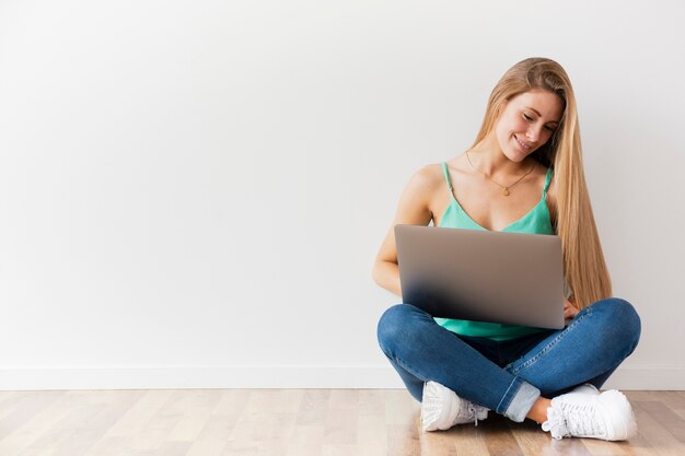 Front view female working on laptop with copy space