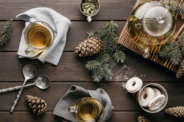 Front view festive arrangement with tea and pine cones