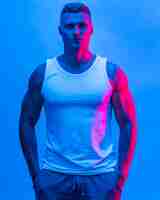 Free photo front view of fit man posing in tank top