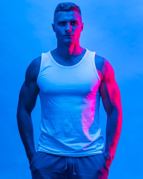 Front view of fit man posing in tank top