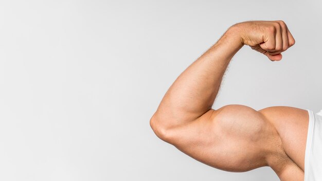 Front view of fit man showing bicep with copy space