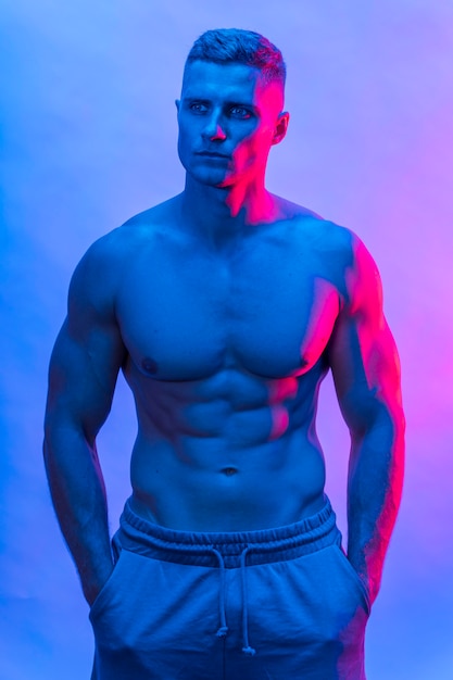 Free photo front view of fit shirtless man posing