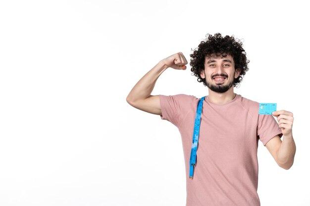 Front view flexing young male with measure tape holding credit card on white background bank horizontal weight human slimming money waist losing