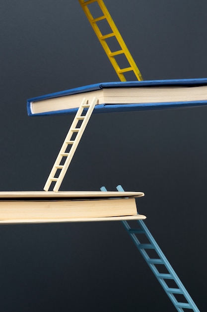 Free photo front view of floating books connected by ladders for education day