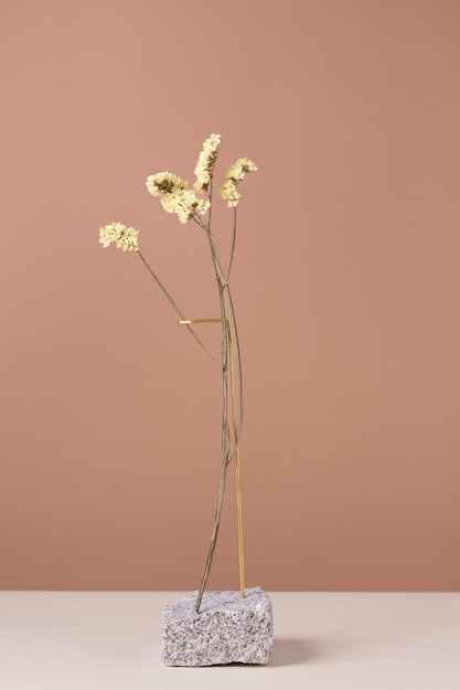 Free photo front view of flower decor on a stone stand