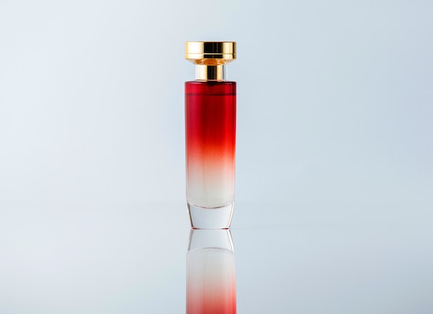 A front view fragrance white and red designed transparent on the light desk