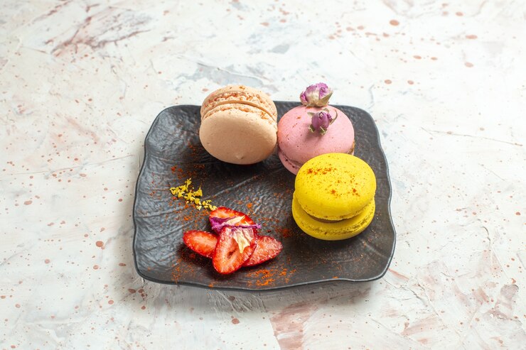 Free Photo front view french macarons inside plate on white table biscuit sweet cake