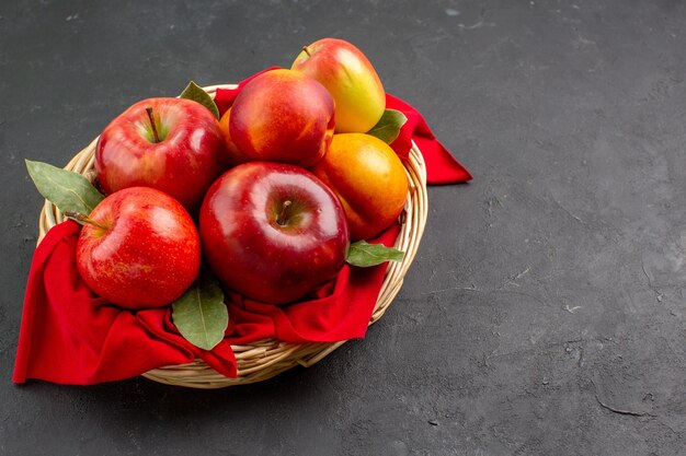 Front view fresh apples  inside basket on a dark table fruit tree fresh ripe