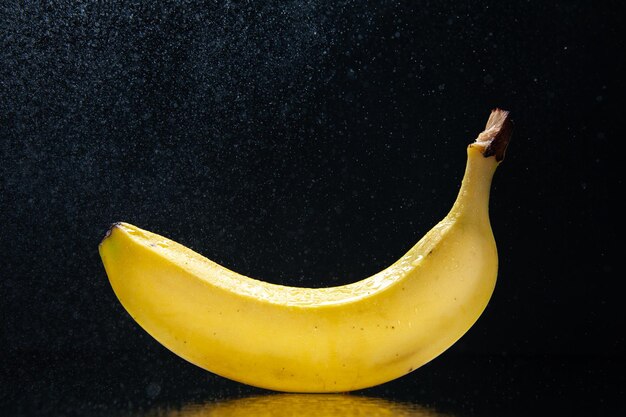 Front view fresh banana on black background color ripe mellow tree exotic tasty darkness photo