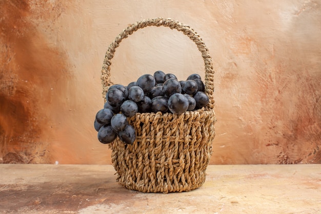 Front view fresh black grapes inside basket on the light background fruit wine color photo