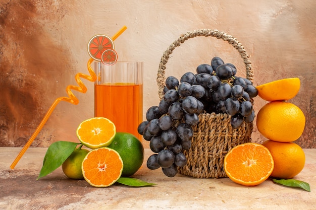 Front view fresh black grapes with orange on a light background fruit mellow photo vitamine tree ripe