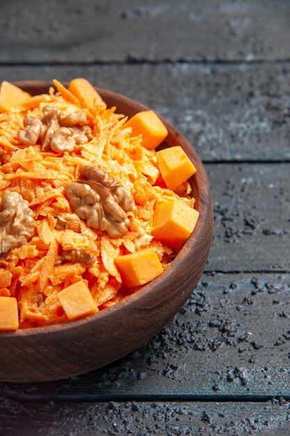 Front view fresh carrot salad grated salad with walnuts and garlic on the dark desk diet nut salad health color