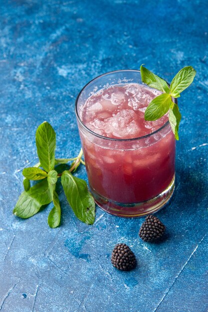 Front view fresh cool lemonade inside little glass with ice on blue background cold drink color water fruit cocktail