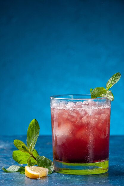 Front view fresh cool lemonade inside little glass with ice on blue background cold juice drink color water fruits cocktail