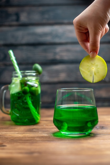 Front view fresh feijoa juice inside can with straw on dark bar fruit photo color drink