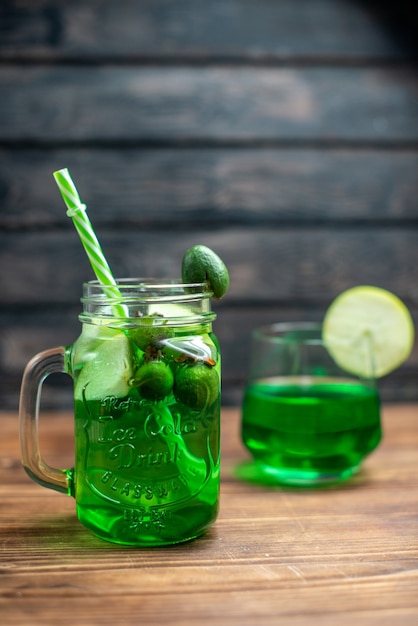 Front view fresh feijoa juice inside can with straw on dark desk bar fruit photo cocktail color drink