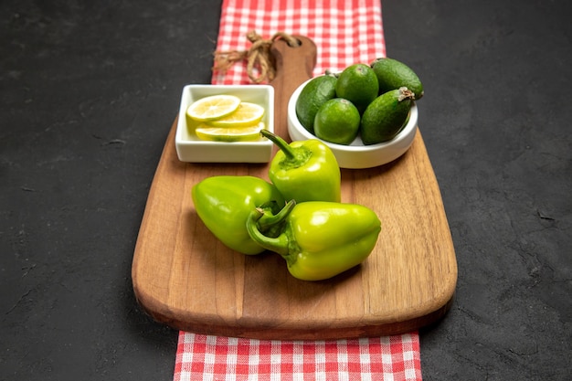 Front view fresh feijoa with green bell-pepper and lemon on dark surface fruit citrus plant meal