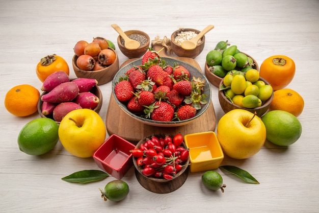 Front view fresh fruits composition on white background photo color berry citrus health tree ripe fruit tasty