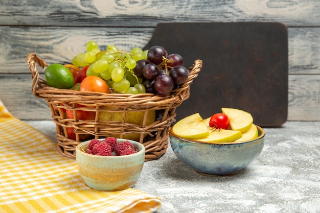 Front view fresh fruits inside basket on grey background fruit ripe mellow