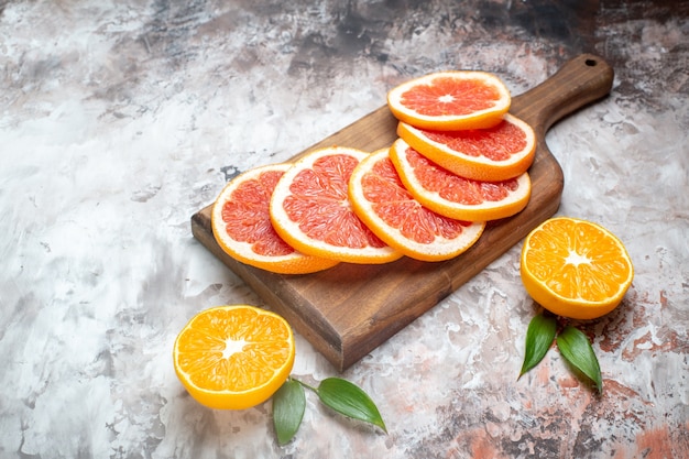 Free photo front view fresh grapefruits sliced fruits on light-table