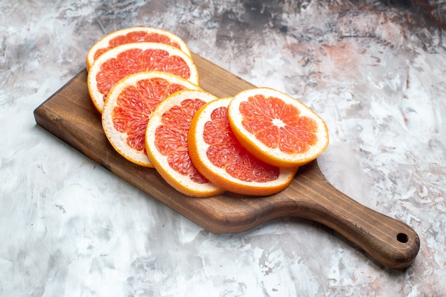 Free photo front view fresh grapefruits sliced on light-table