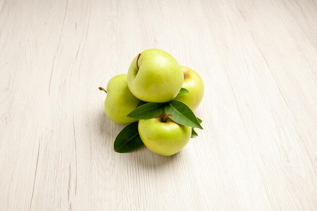 Front view fresh green apples mellow and ripe fruits on a white desk plant fruit color fresh green tree