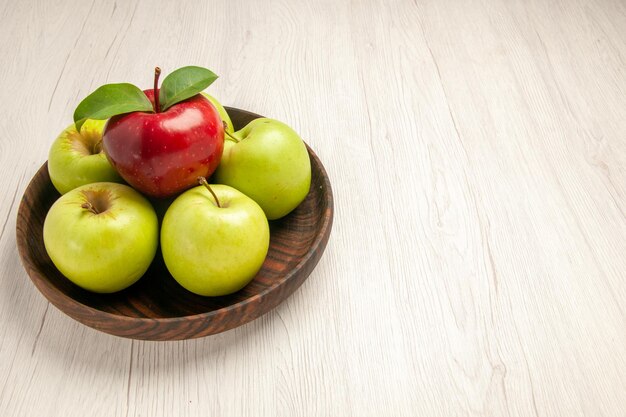 Front view fresh green apples ripe and mellow fruits on white floor fruit color tree fresh plant red