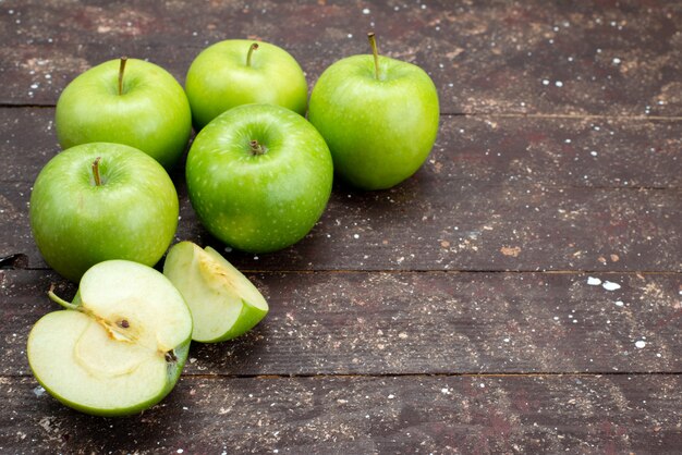 Front view fresh green apples sliced and whole on dark