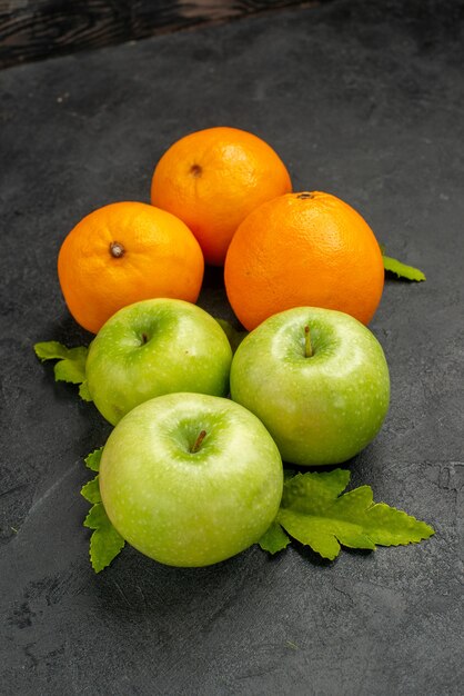 Front view fresh green apples with oranges on a grey background ripe photo color tree fruit juice vitamine