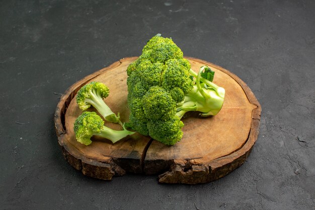 Front view fresh green broccoli plant from cabbage family on dark background