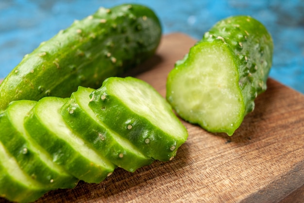 Front view fresh green cucumbers sliced on blue background meal salad health photo ripe food diet color