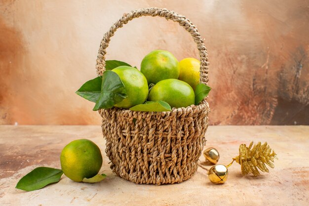 Front view fresh green tangerines inside basket on light background color mellow fruit photo juice xmas