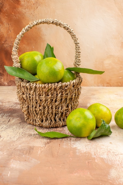 Free photo front view fresh green tangerines inside basket on a light background juice photo color mellow fruit