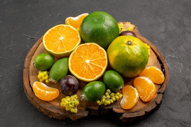 Front view fresh green tangerines with feijoas on a dark space