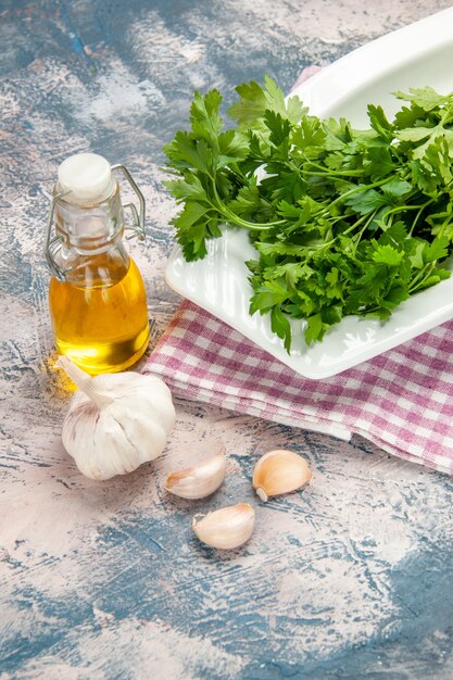 Front view fresh greens with oil on a light background salad color ripe photo meal