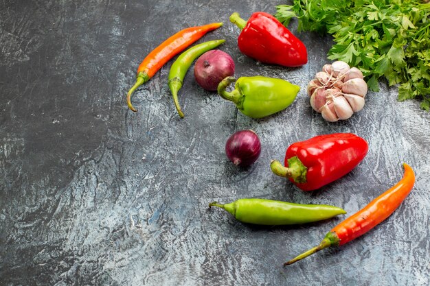 Front view fresh greens with peppers and garlic on light-grey salad meal photo dish food healthy life colors