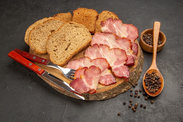 Front view fresh ham slices with buns and bread slices on a dark snack meat color photo food meal