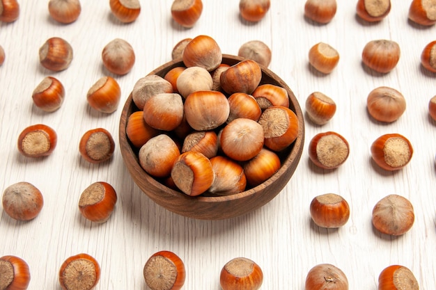 Free photo front view fresh hazelnuts on white desk nut snack plant walnut peanut