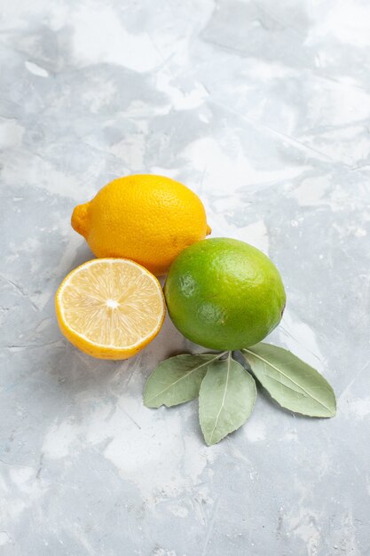 Front view fresh lemons juicy and sour on white desk tropic exotic fruit citrus